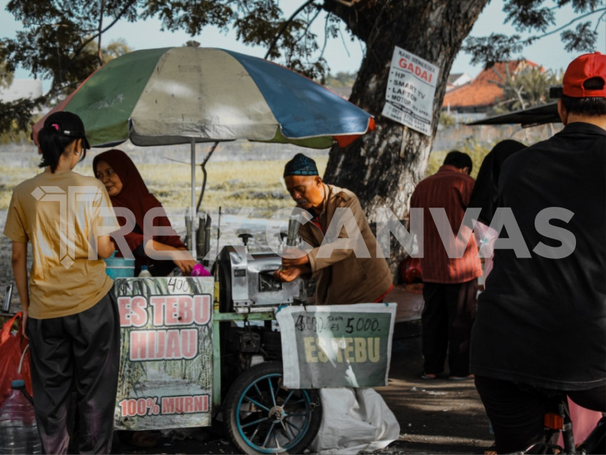 someone selling sugar cane ice on the street