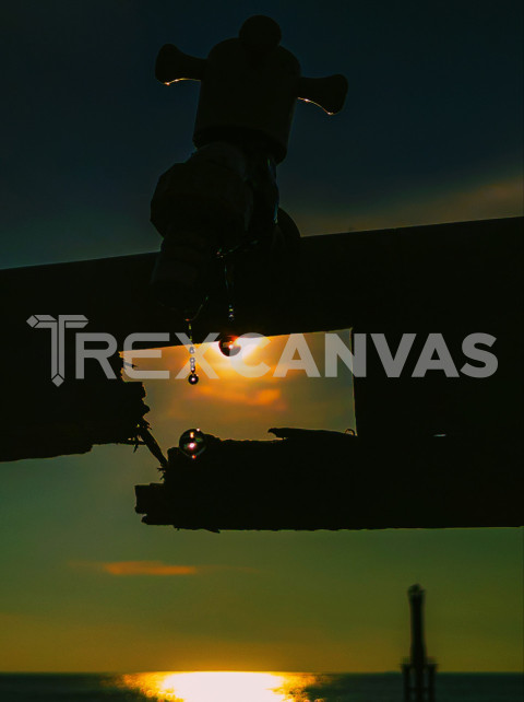 Water drops from the faucet with a sunset background