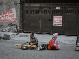 2 people singing on road