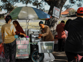 someone selling sugar cane ice on the street