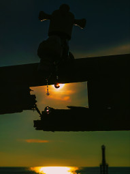 Water drops from the faucet with a sunset background